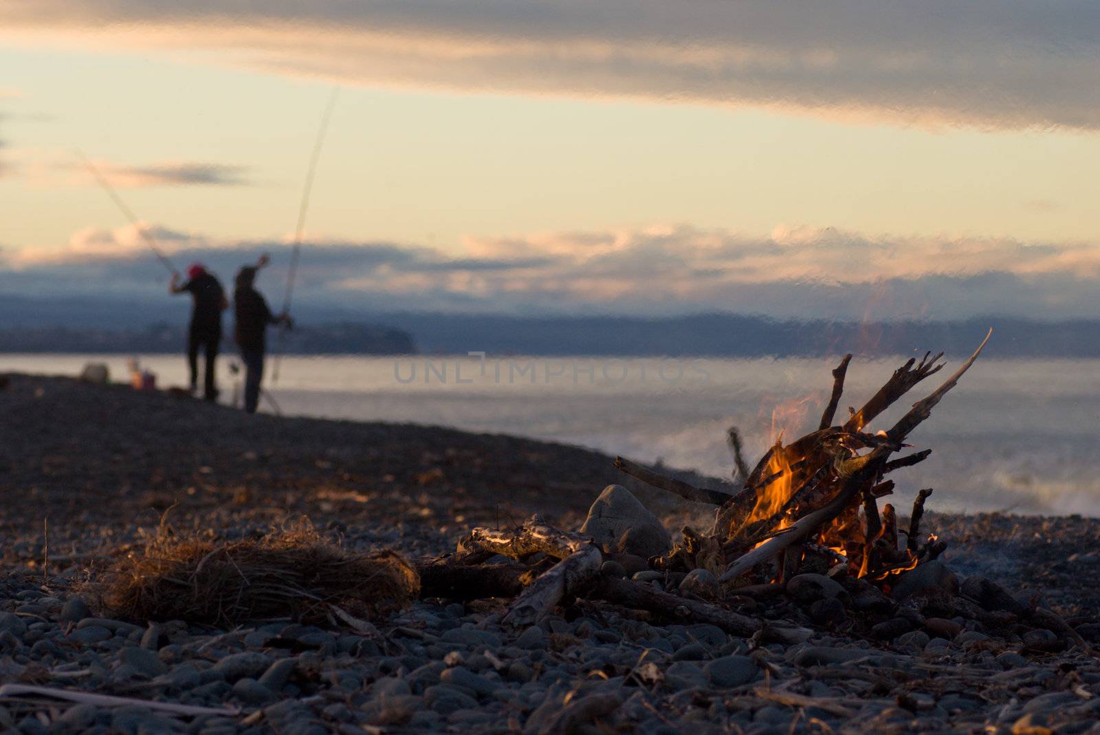 A warm fire on the beach and surfcasting on a cool winter afternoon. Haumoana Beach, Hawke's Bay, New Zealand