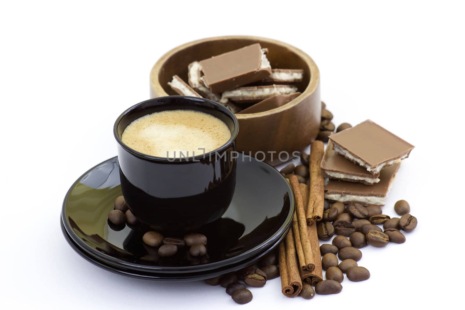 cup of italian espresso with cinnamon, coffee beans and chocolate