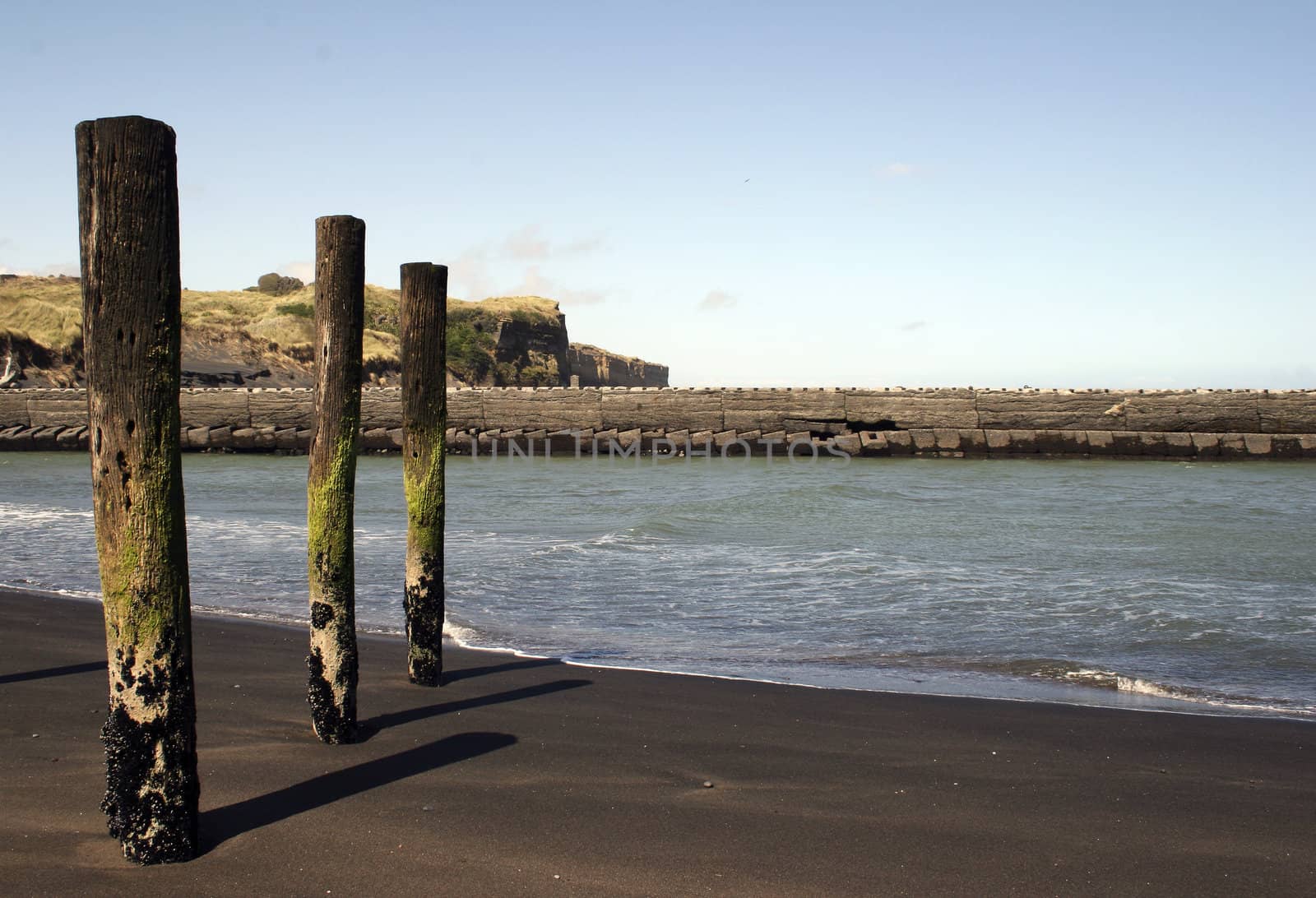 Poles at rivermouth at Patea, Taranaki, New Zealand