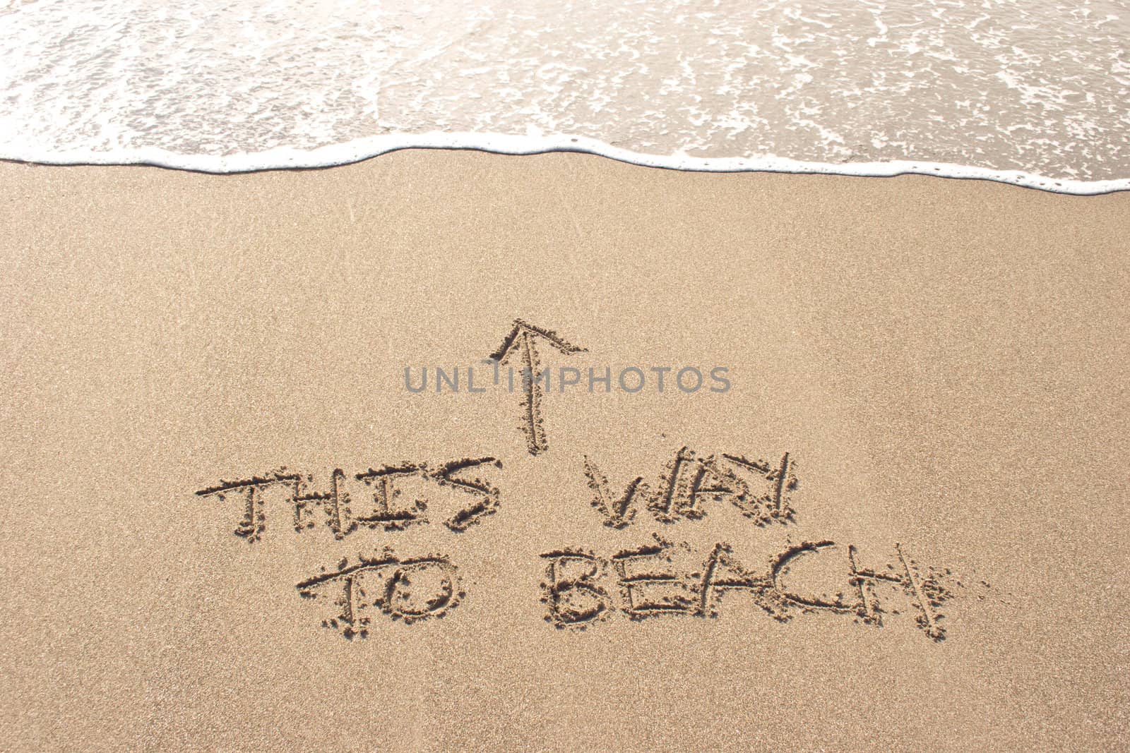 This way to beach written in the sand at Haumoana Beach, Hawke's Bay, New Zealand