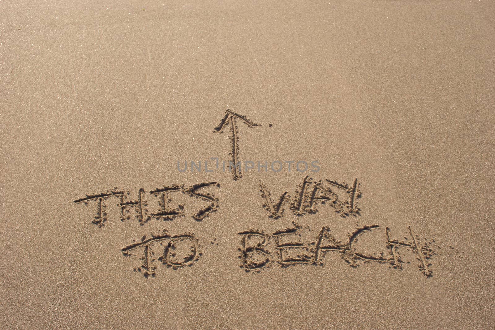 This way to beach written in the sand at Haumoana Beach, Hawke's Bay, New Zealand