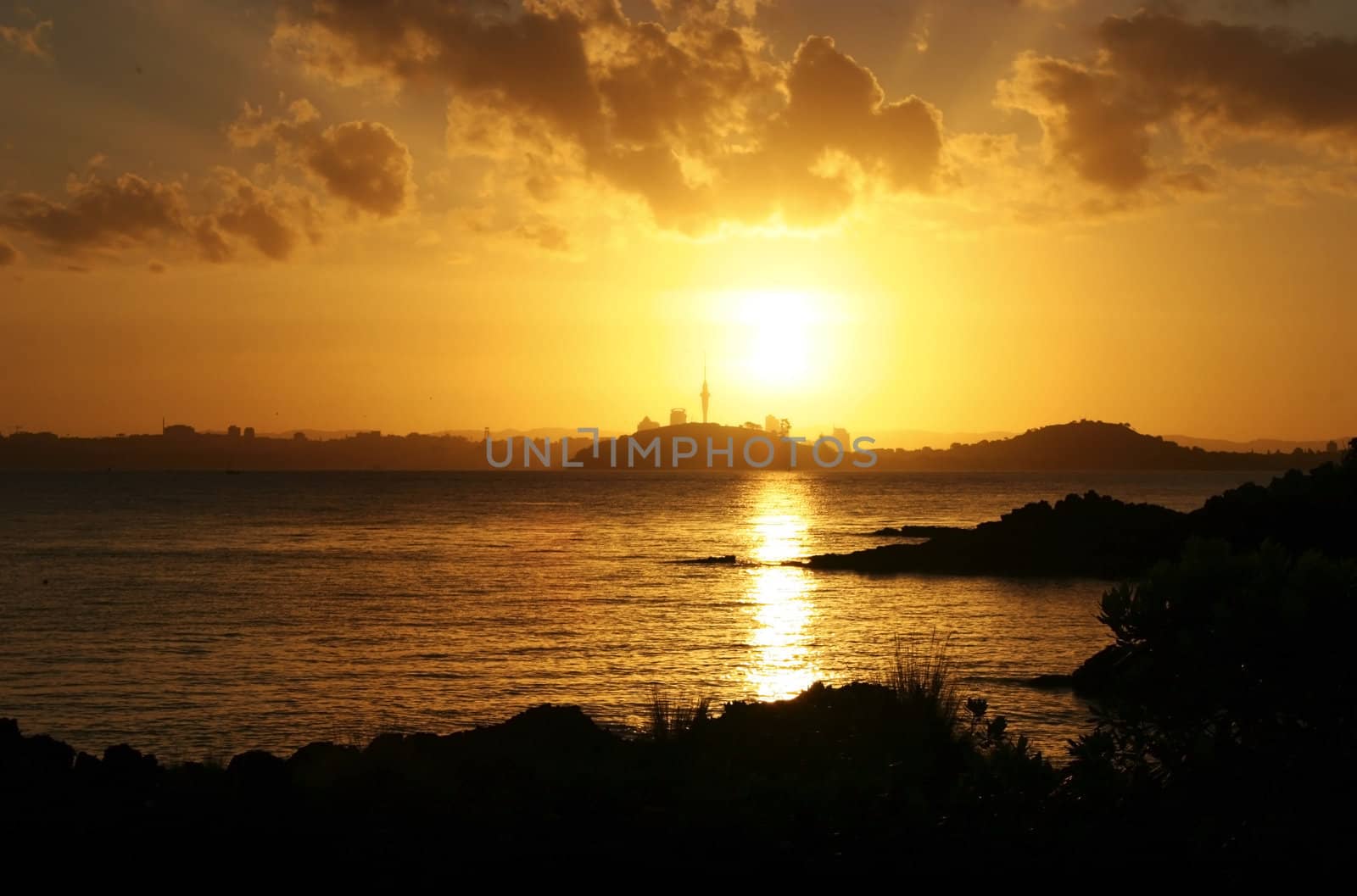 Sunset on Auckland City including the skytower. Shot from Rangitoto Island