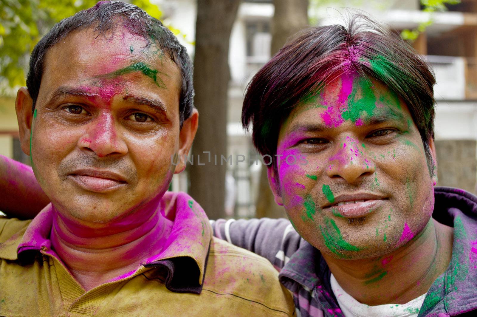 Two unidentified Paint covered Delhi residents attend in the spring & harvest festival, Holi. Colored paint smeared on faces to in-distinguish caste, class and race. New Delhi, India.