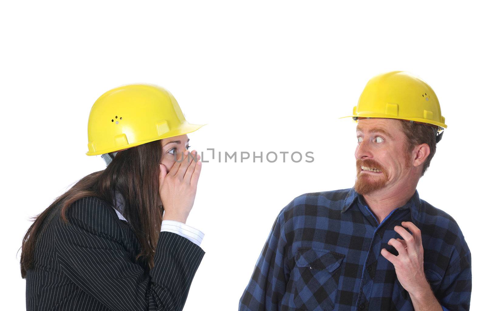 businesswoman gestures telling something to afraid construction worker on workplace