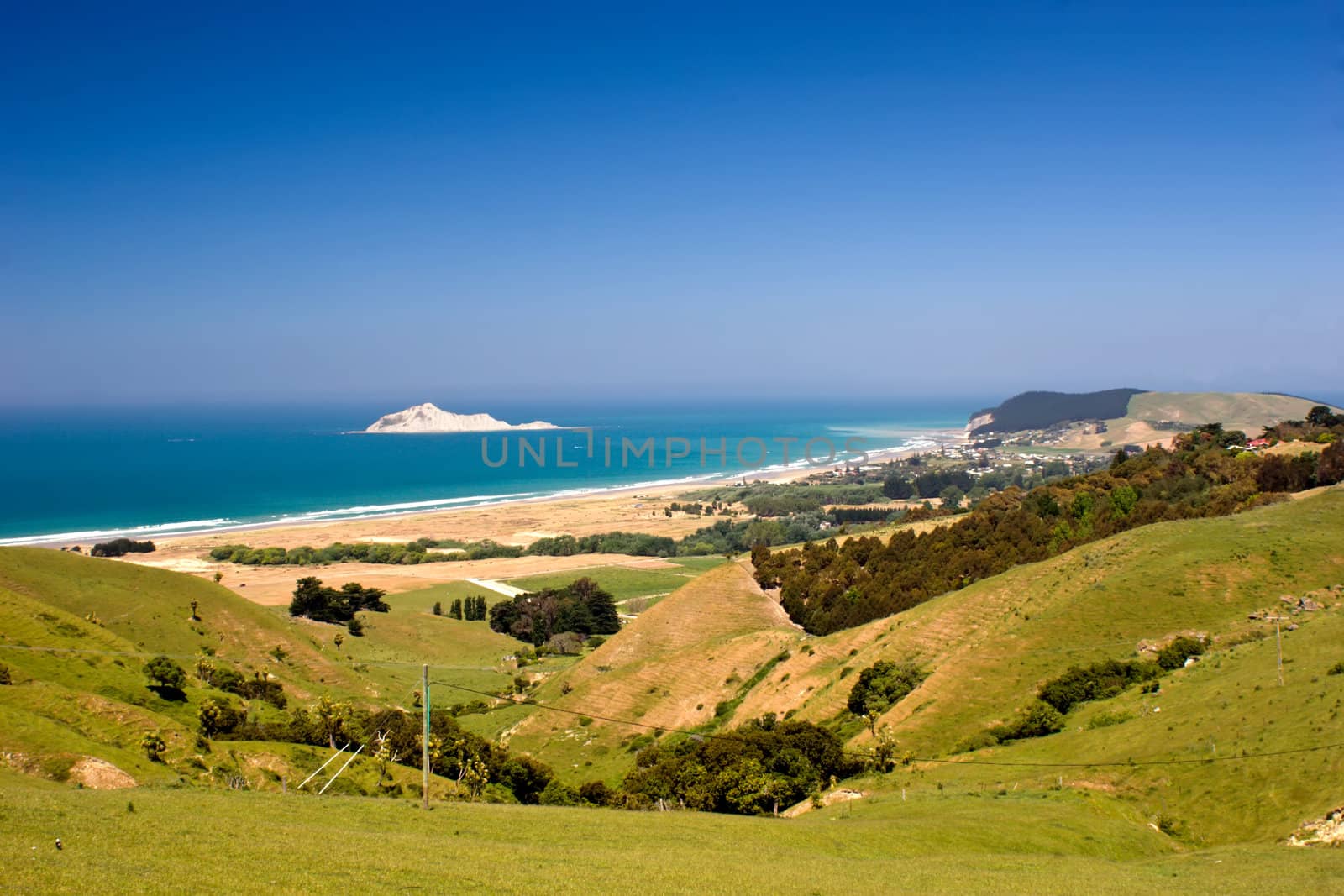 The view down to Bare Island and the coastal settlement of Waimarama in Hawke's Bay, East Coast of the North Island, New Zealand.