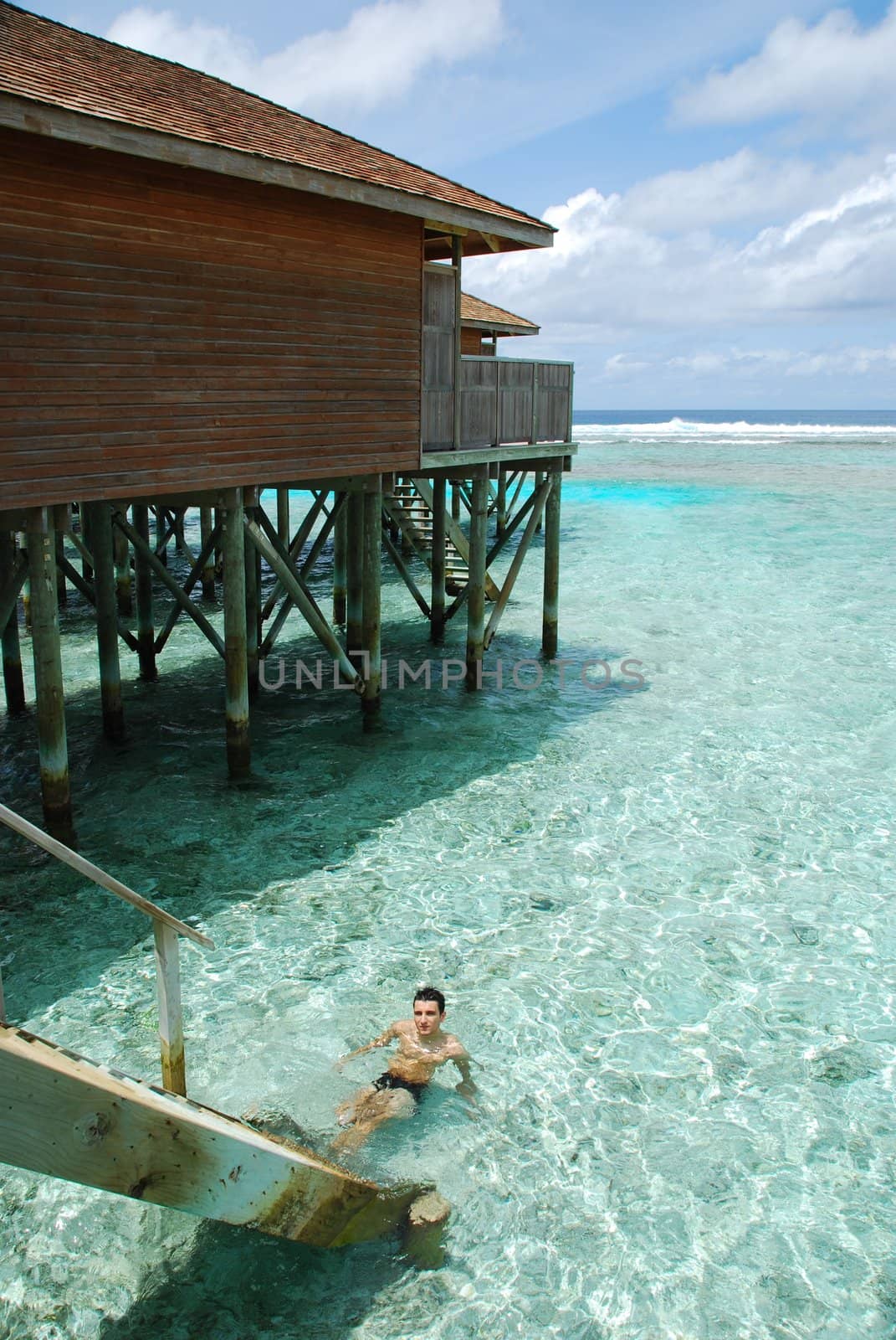 young adult relaxing on translucid water in a Maldivian Island