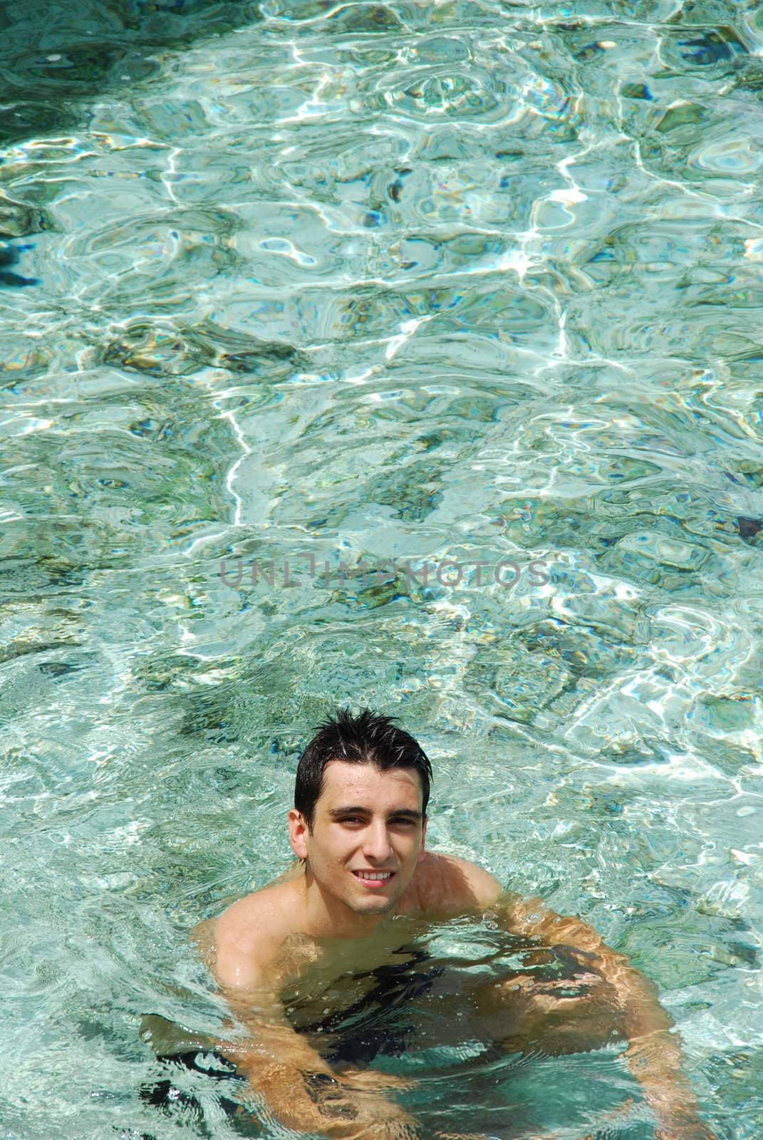 young adult smiling on translucid water in a Maldivian Island