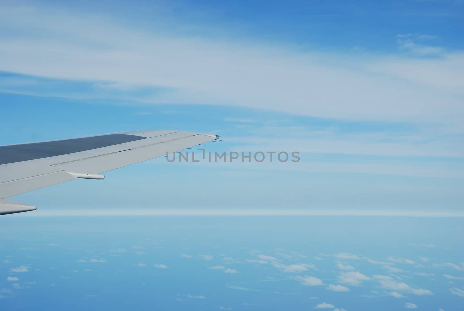 photo of a airplane wing and clouscape scene