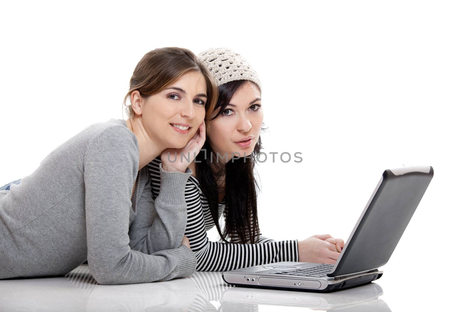 Two female young students working with a laptop