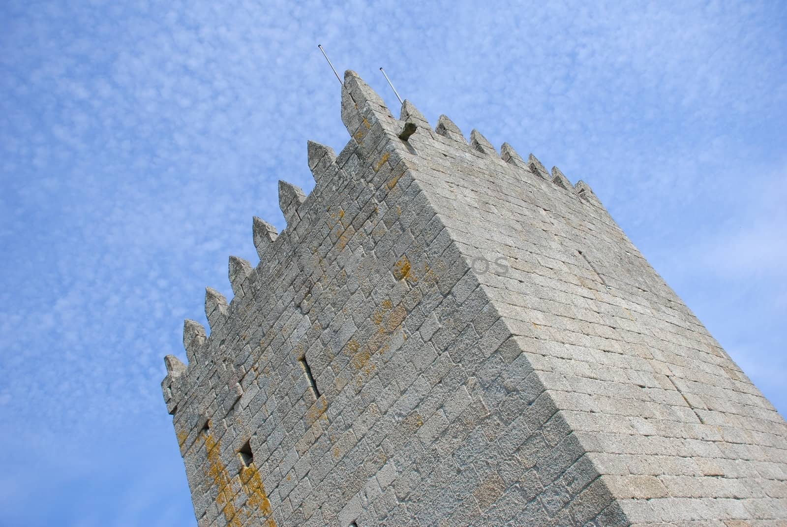Tower of a castle against the background of blue sky