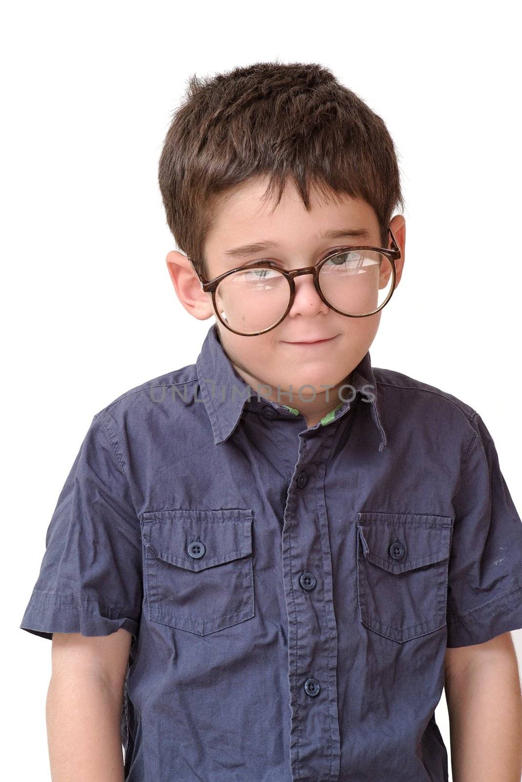 Little boy in funny round spectacles stands isolated