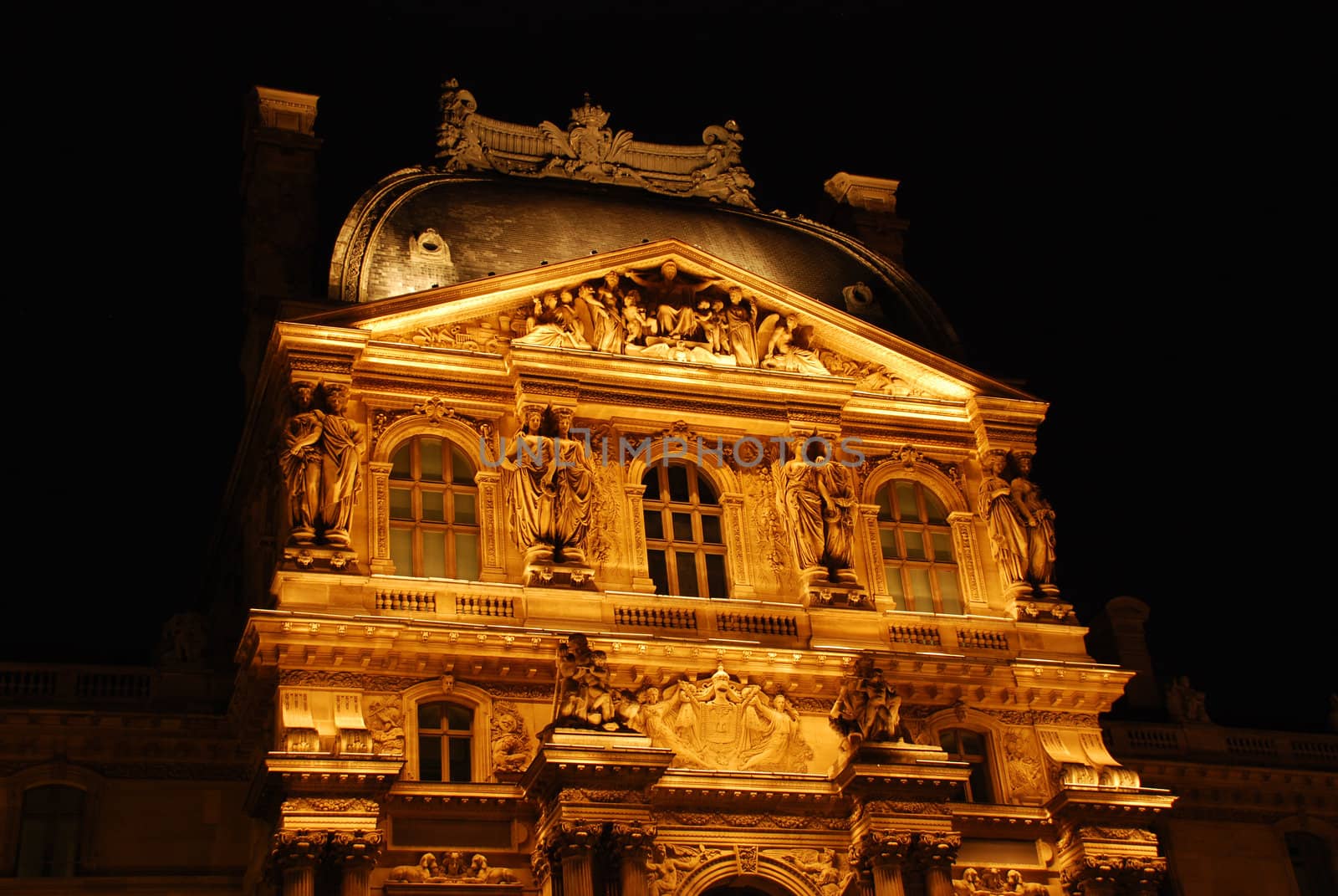 The Louvre in Paris, France at night