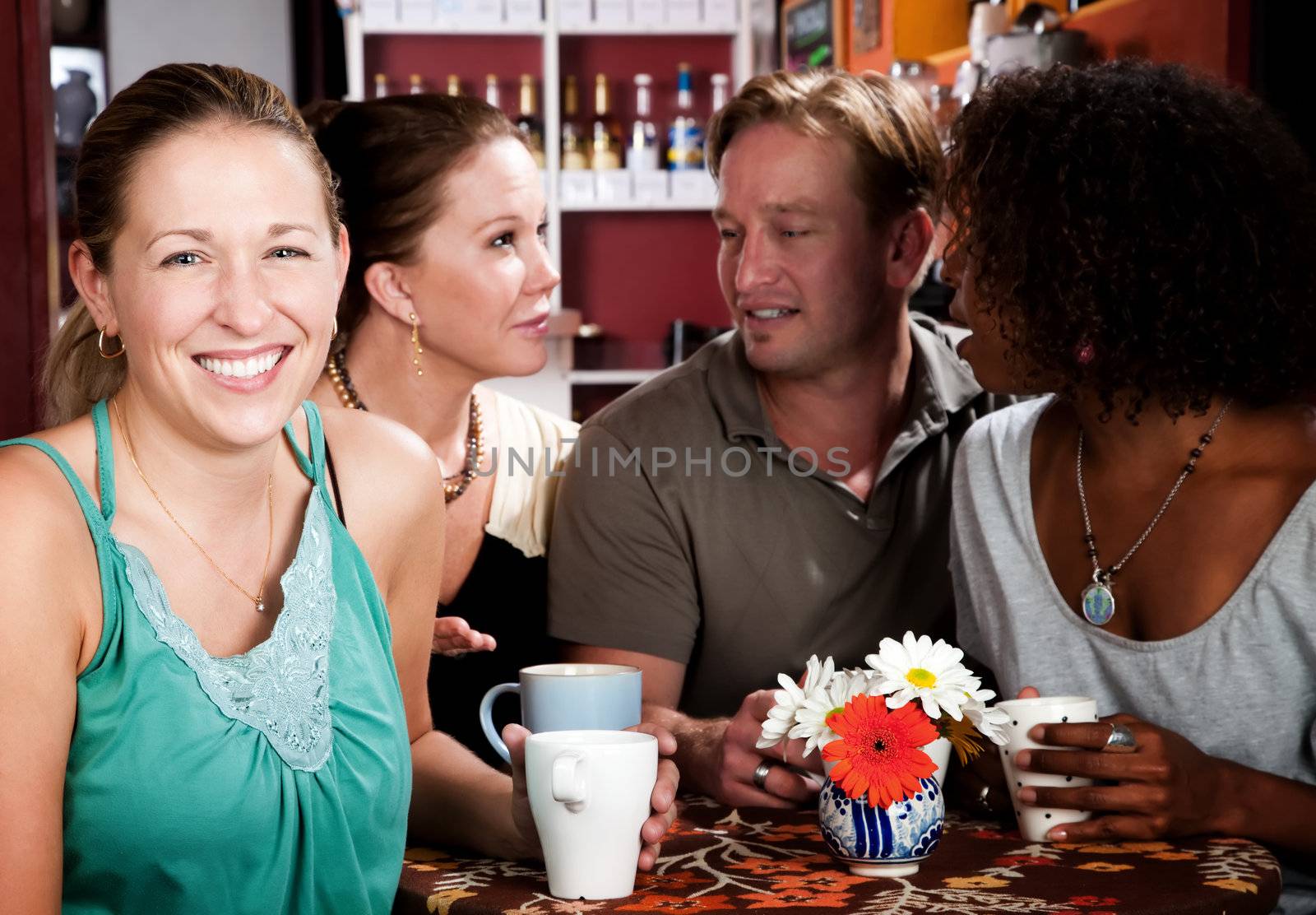 Diverse group of four friends in a coffee house