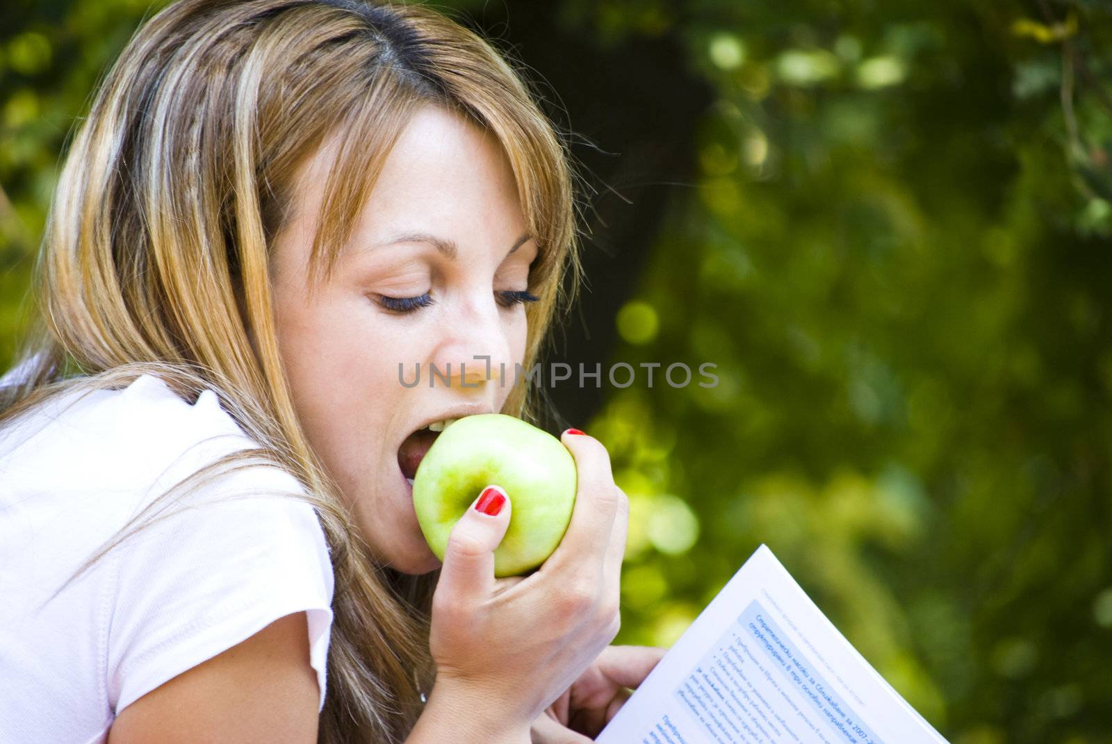 beautiful young woman working out with laptop and reading books