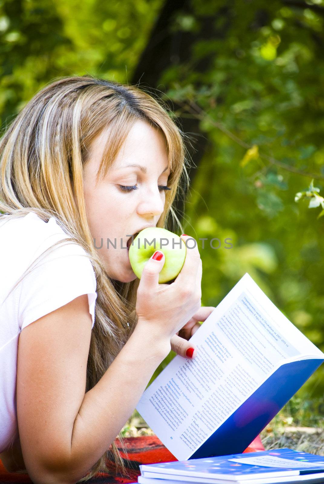 beautiful young woman working out with laptop and reading books
