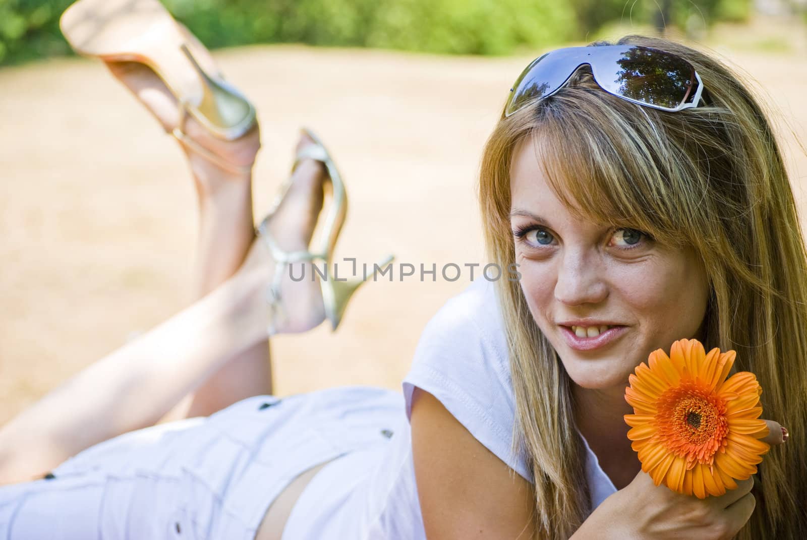 happy young smiling woman laying on ground
