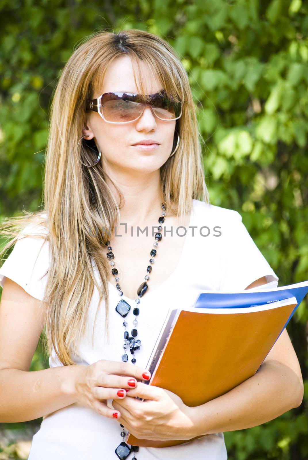 young beautiful woman holding books by Dessie_bg