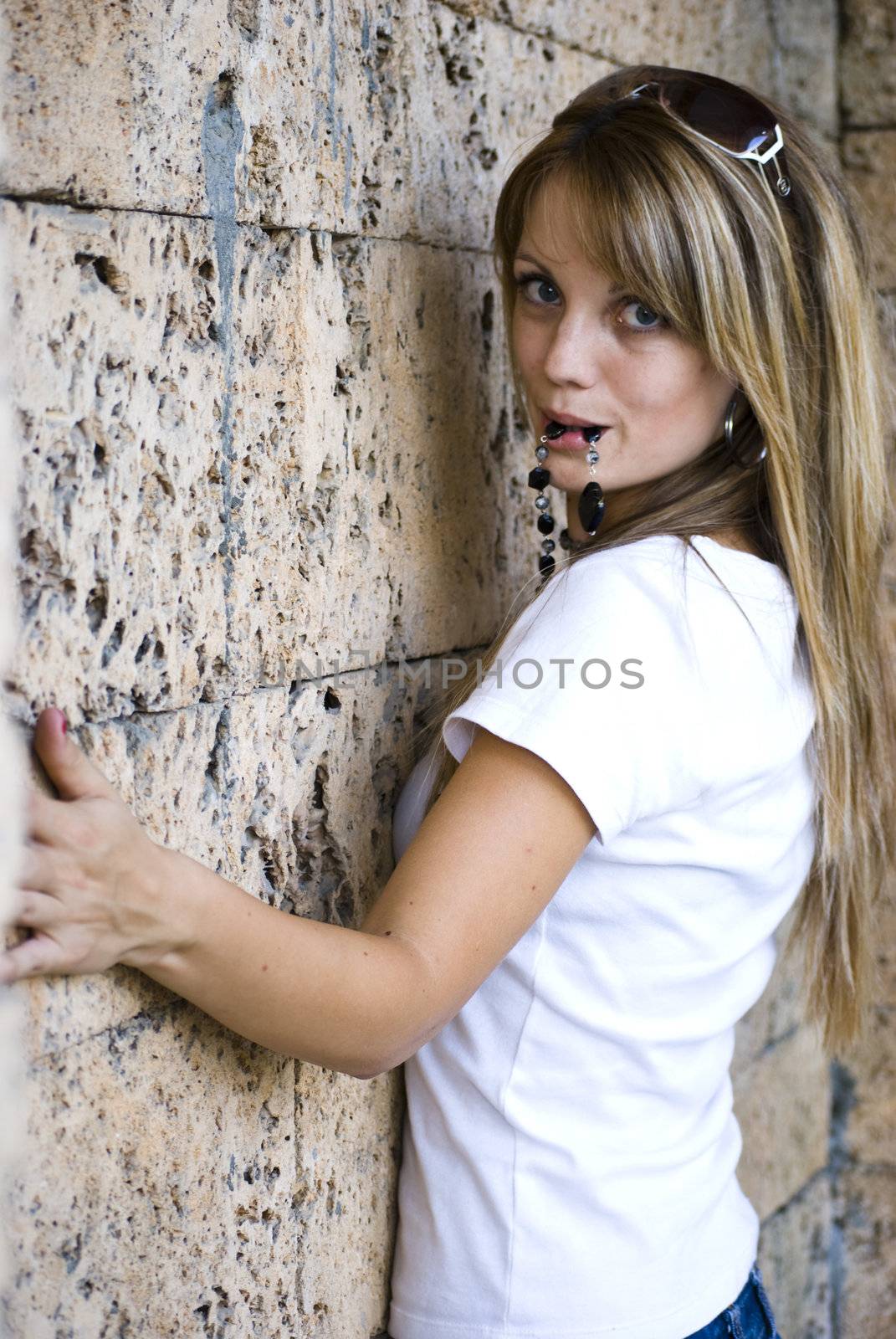 beautiful young model posing on wall