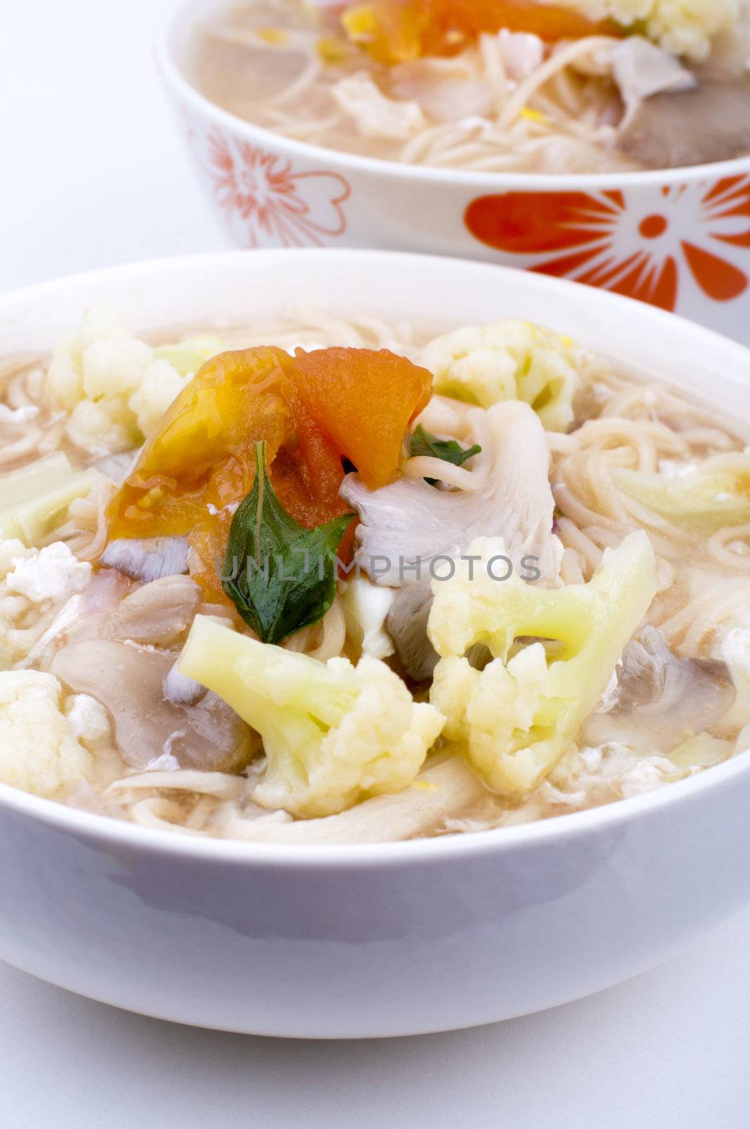 Asian Vegetarian soup noodles isolated on white.