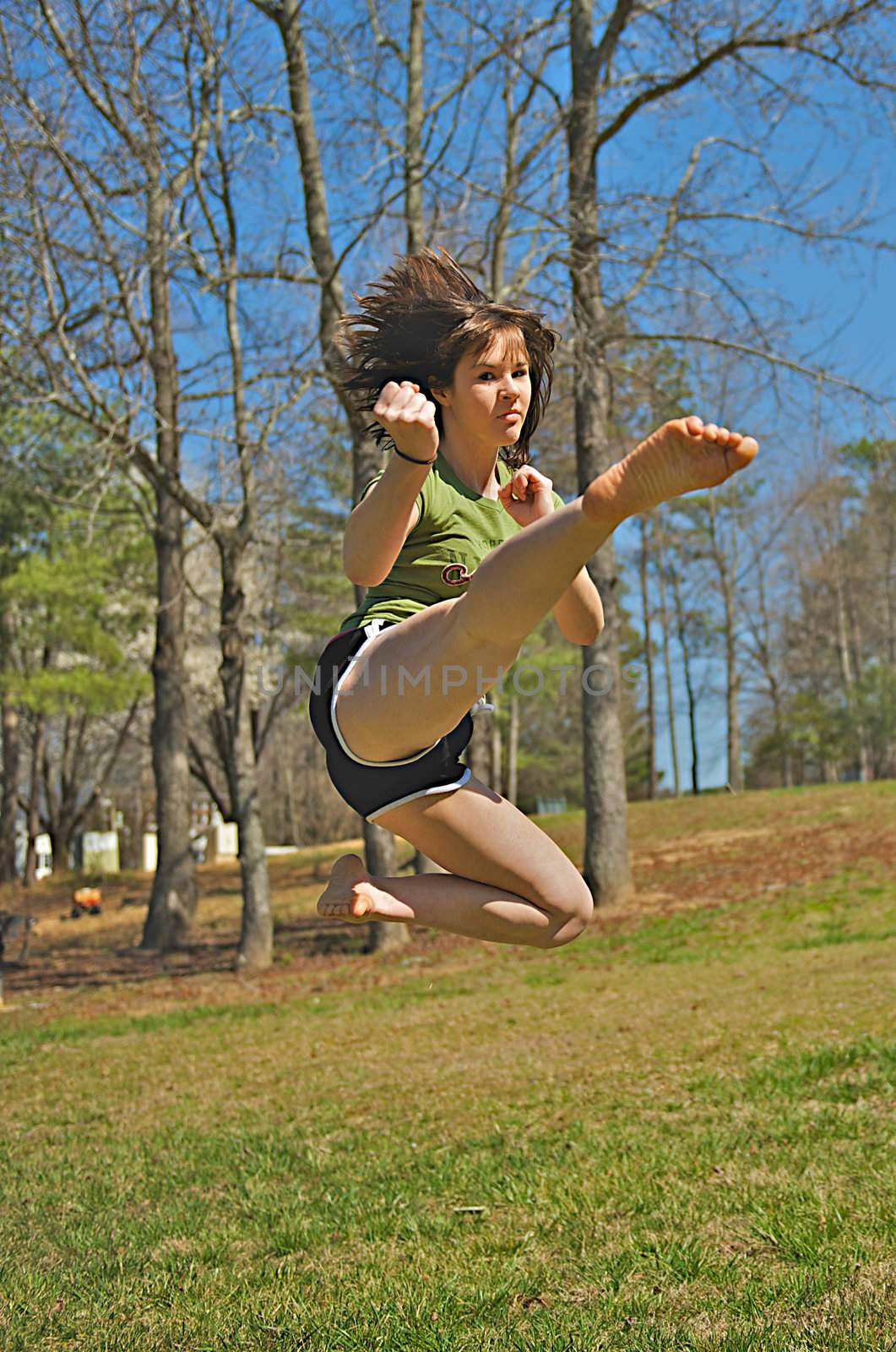 Teen girl performing martial arts techniques.