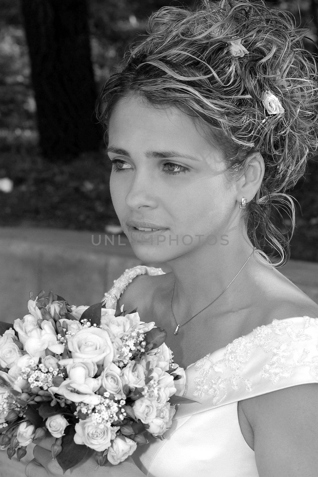 Portrait of young adult bride holding bouquet of flowers.