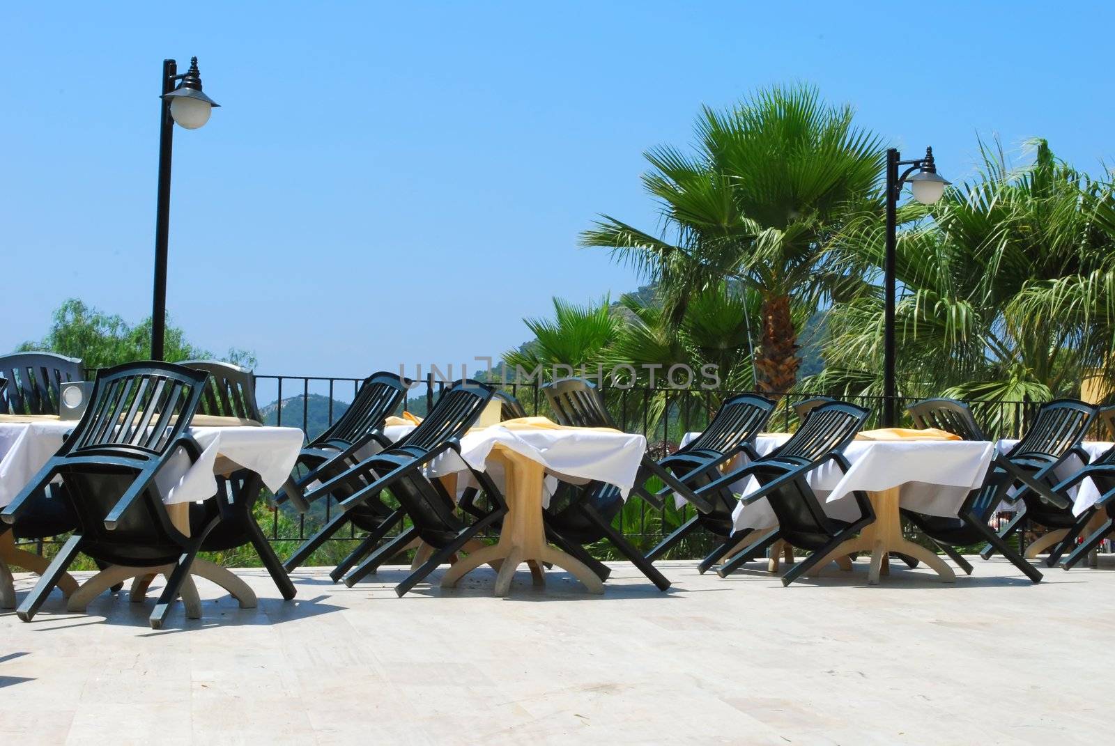 Empty Summer Cafe Open Air. Wind is blowing. It's daytime. There is nobody