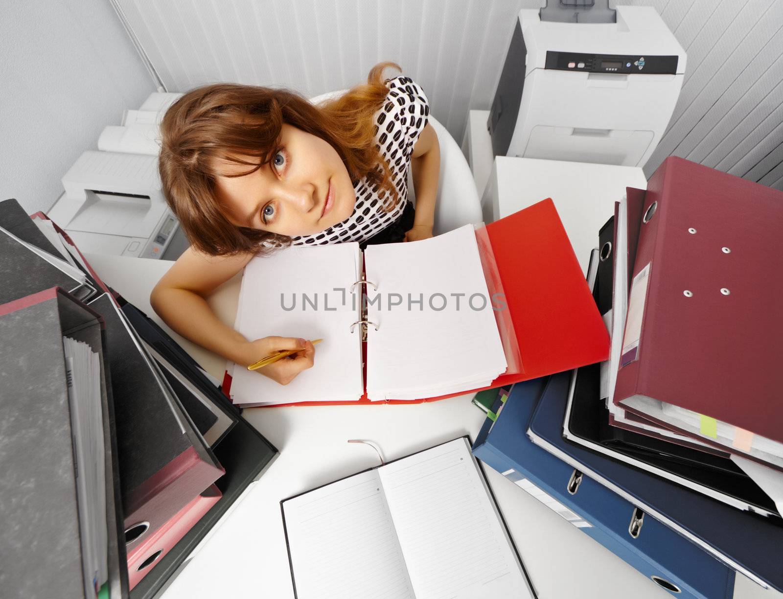 Funny accountant in the workplace among folders with documents