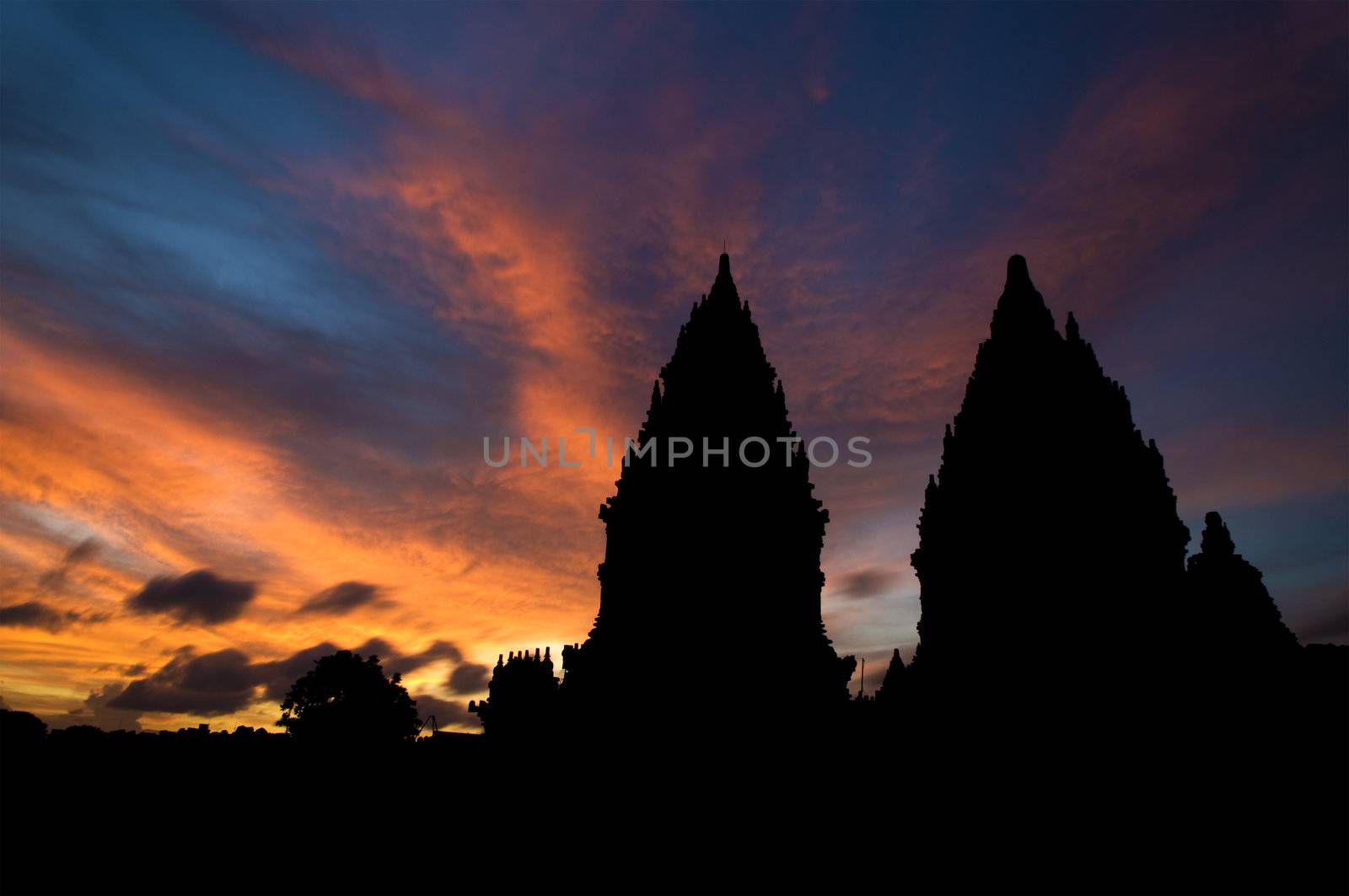 Dramatic sky with sun setting at Hindu temple Prambanan. Indonesia, Central Java, Yogyakarta