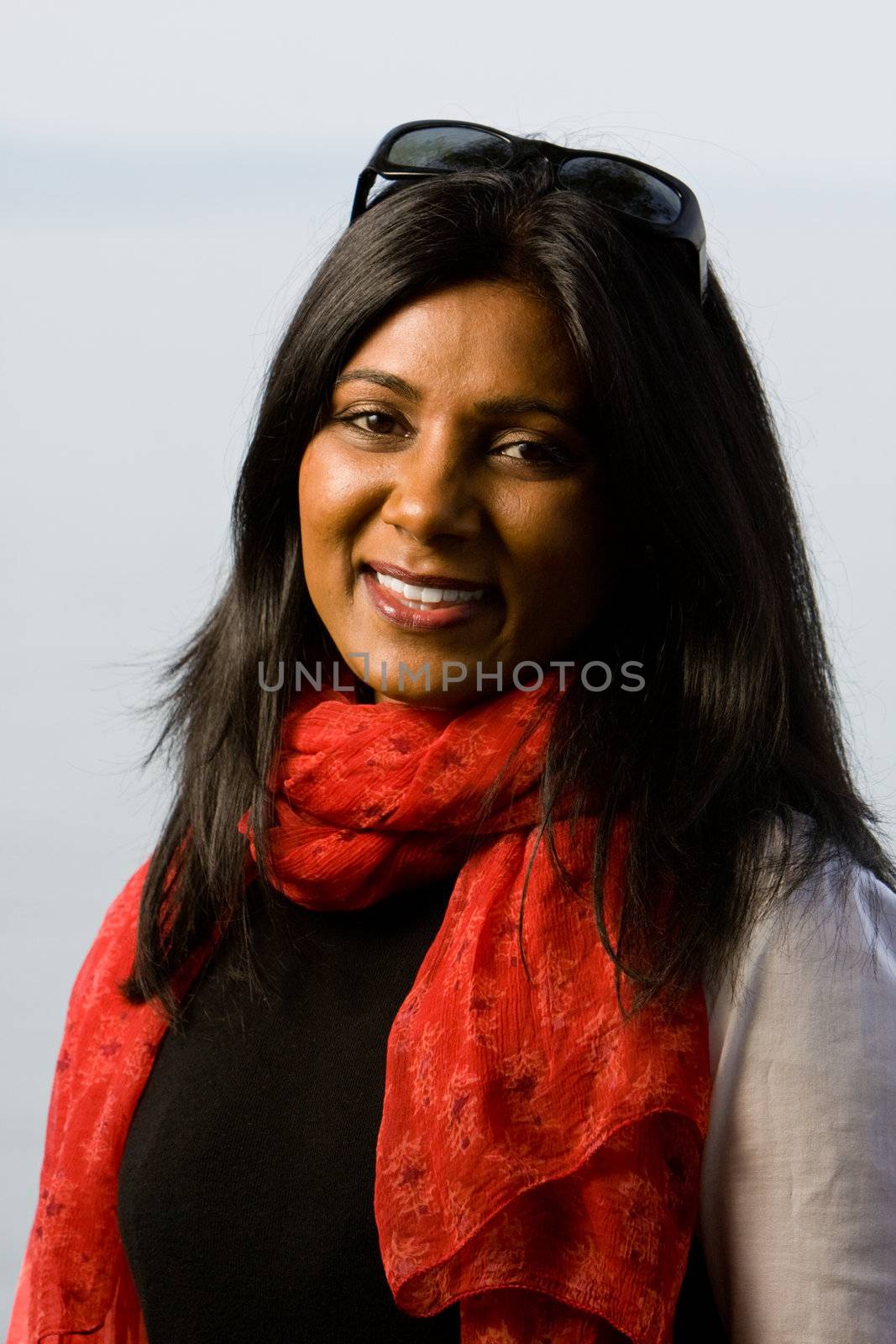 Pretty indian girl smiling outdoors in the park against a nature background