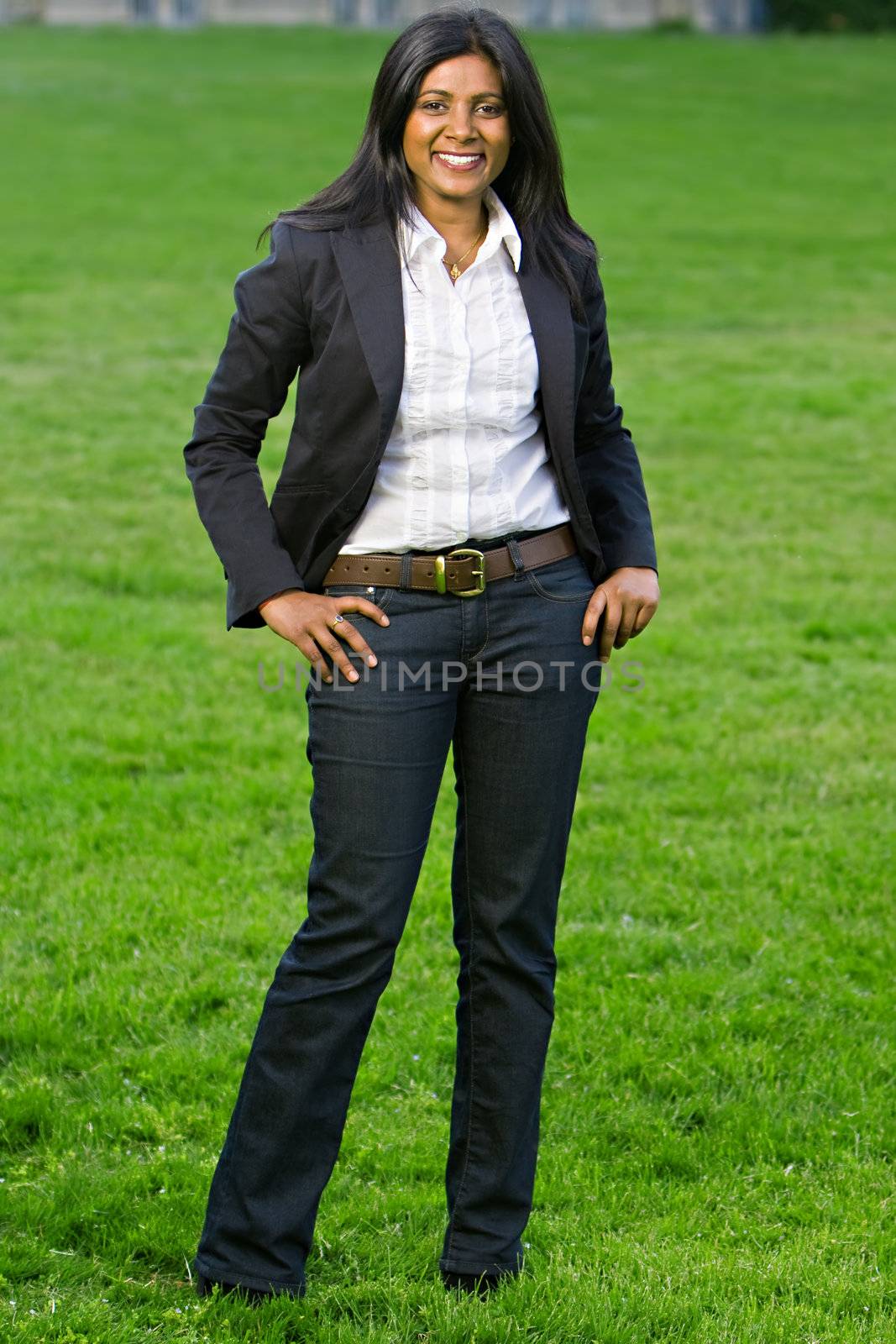 Pretty indian girl smiling outdoors in the park against a nature background