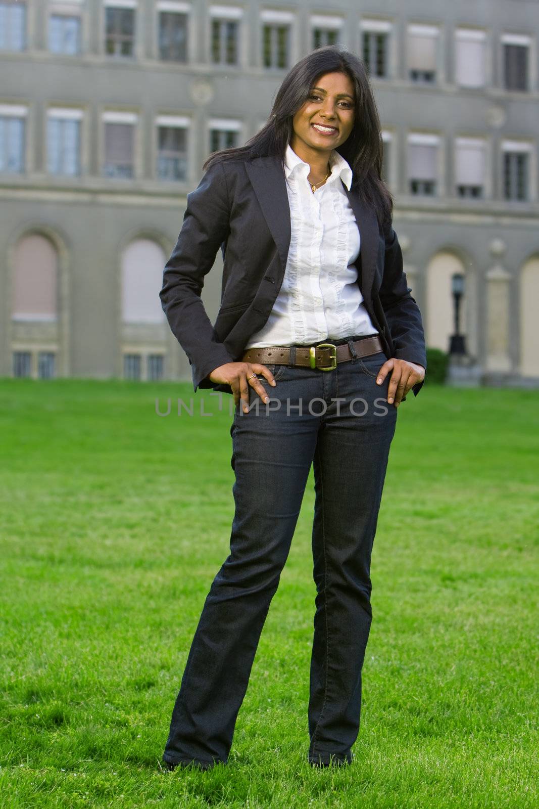 Pretty indian girl smiling outdoors in the park against a nature background