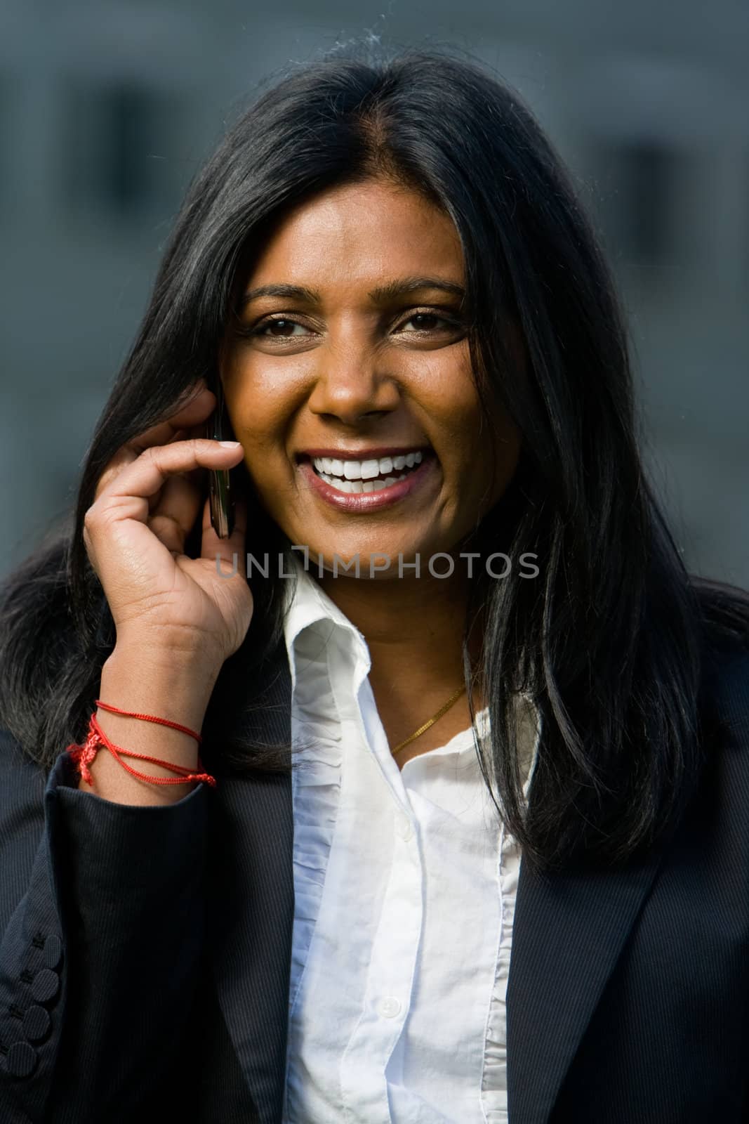 Pretty indian girl using mobile or handphone for communication