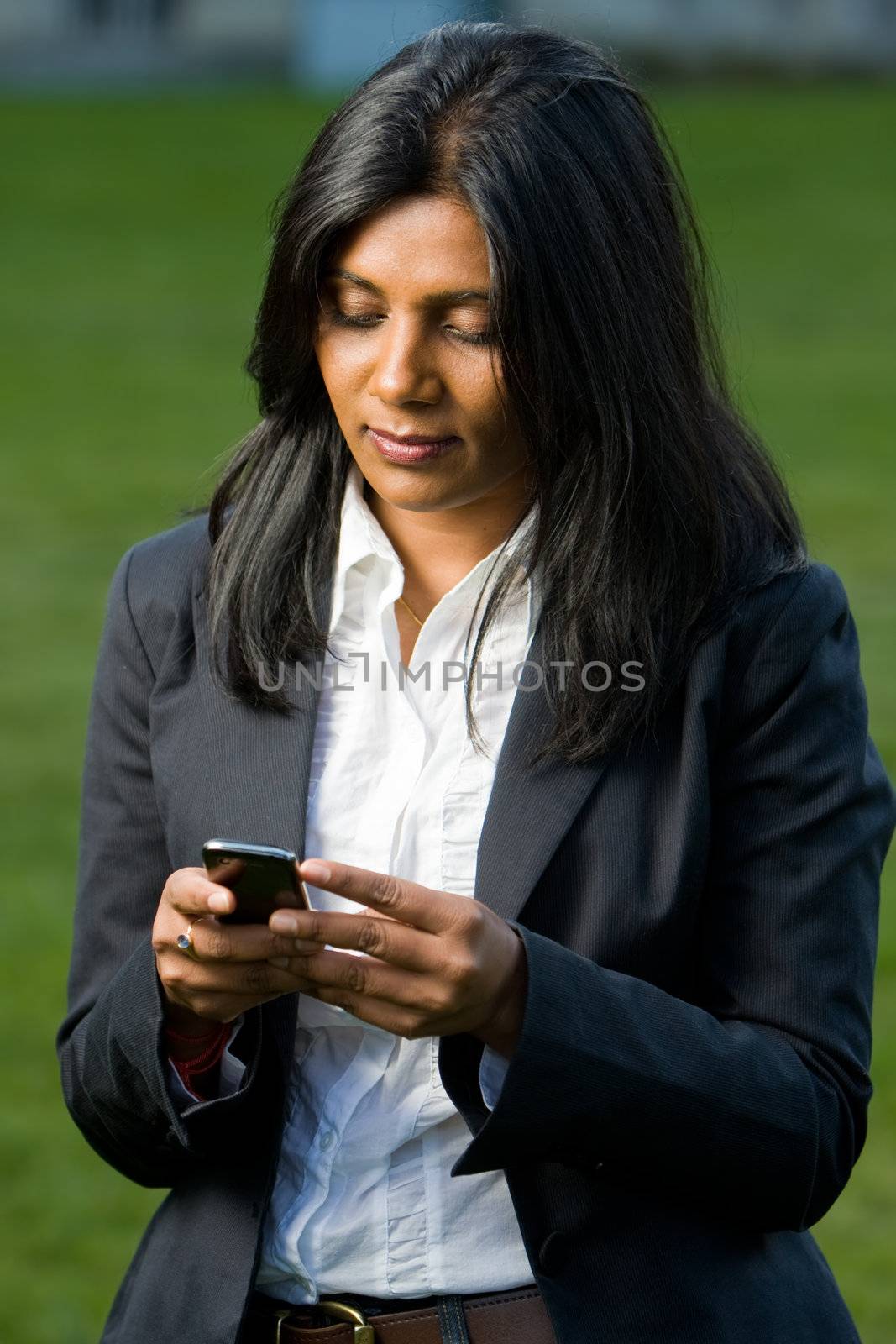 Pretty indian girl using mobile phone by hfng