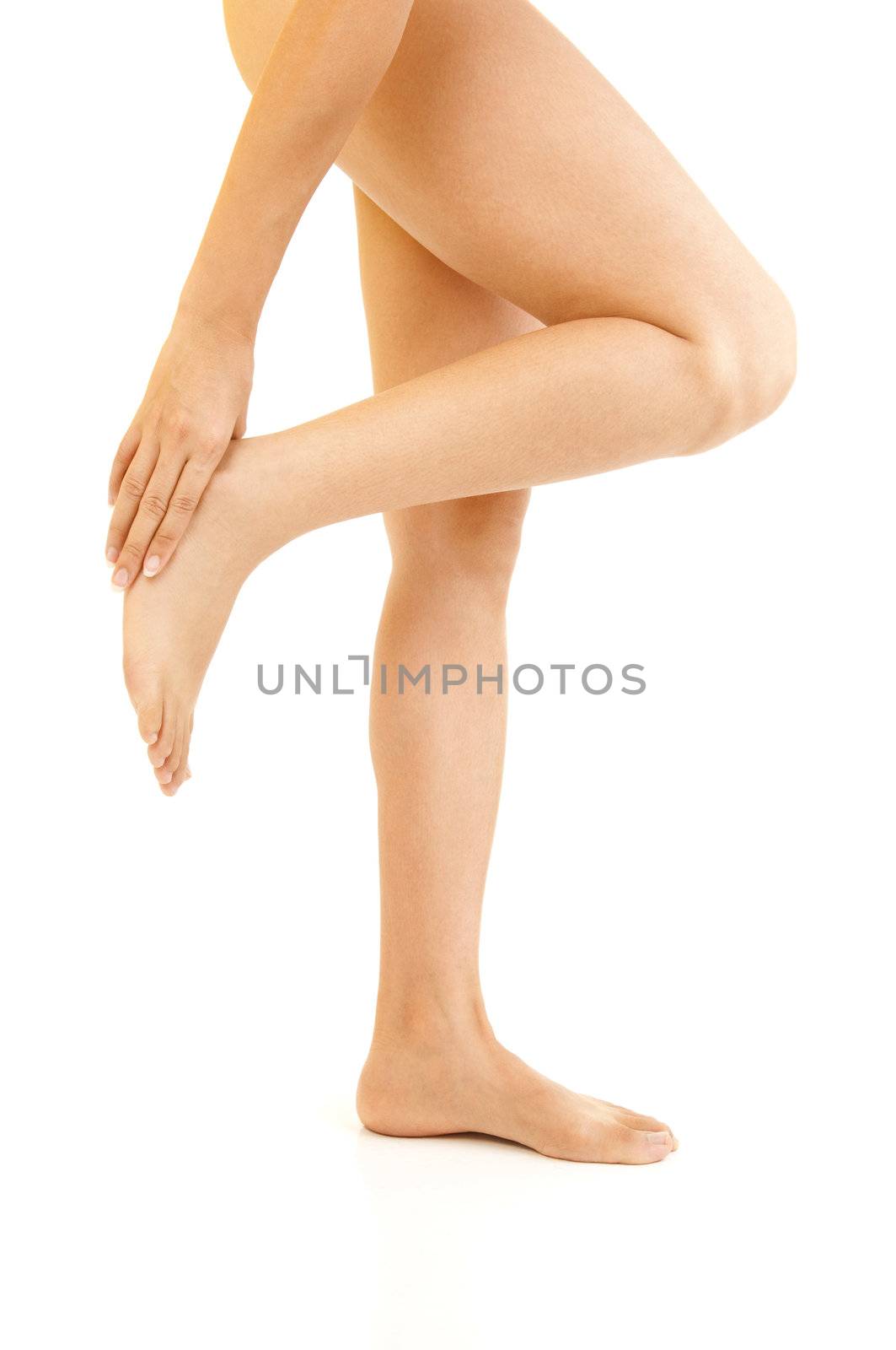 Woman holding sore ankle, on white background.