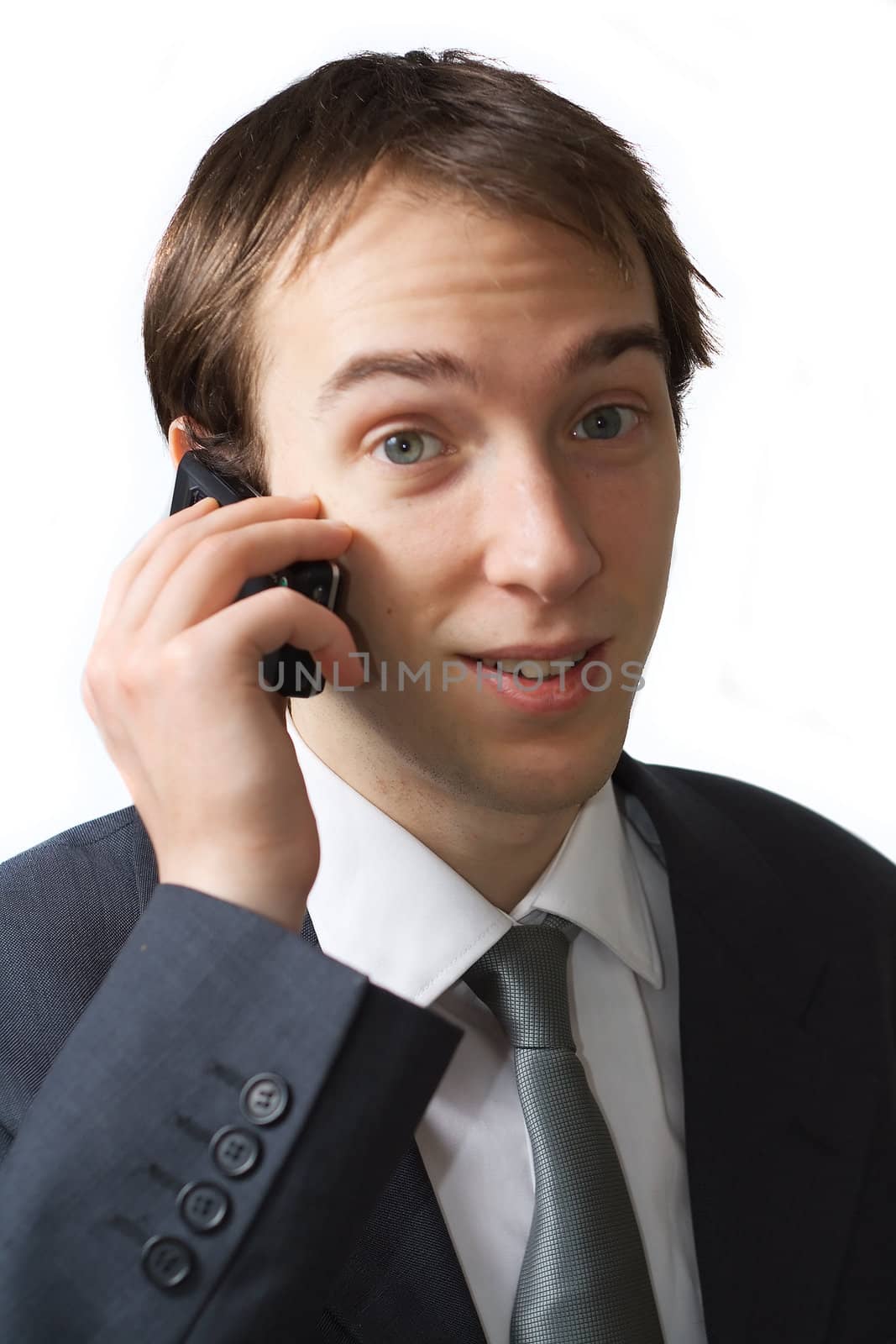 Young professional talks on the phone, isolated over white