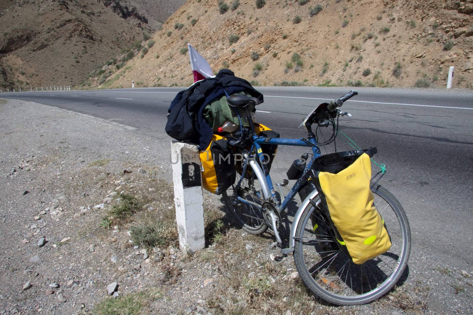 Tourist bicycles with heavy yellow bag. Armenia.