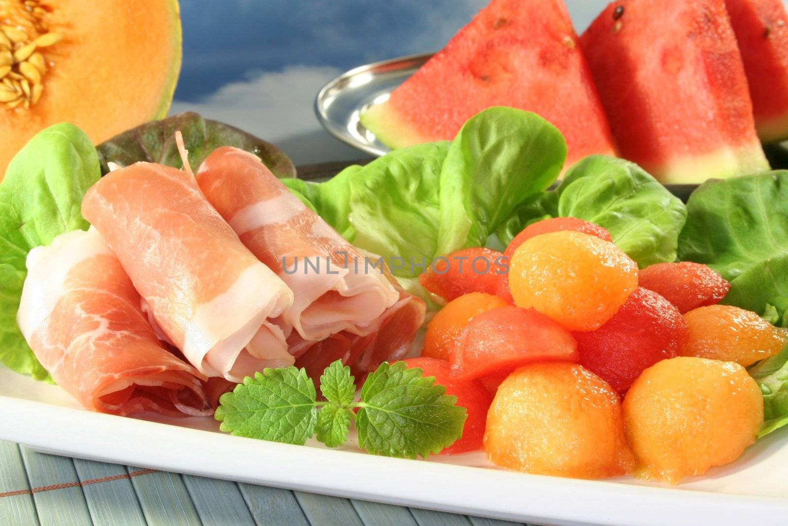 colored melon balls with ham and lemon balm