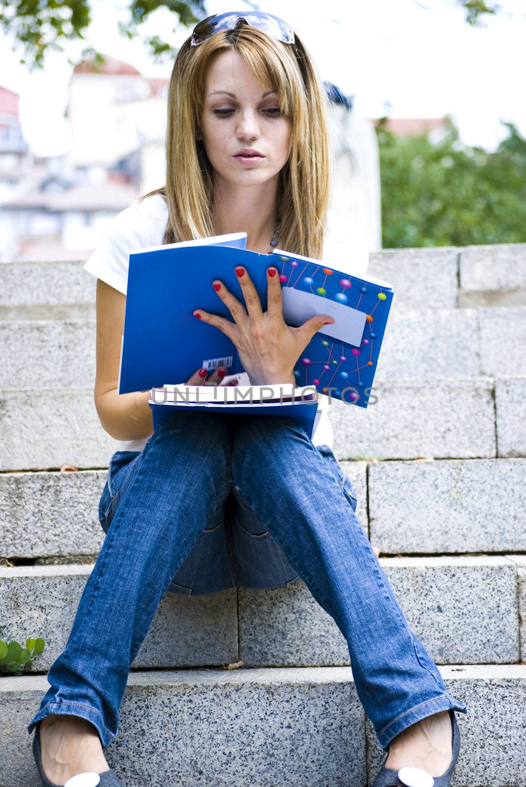 beautiful young woman reading book outdoor
