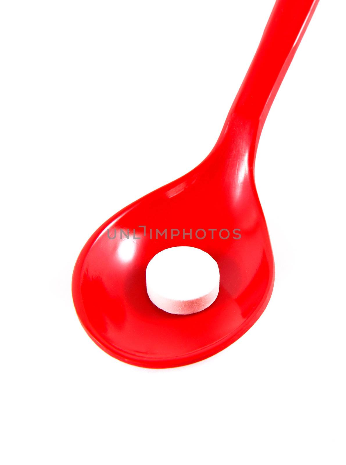 a medicine on red spoon isolated by nuchylee