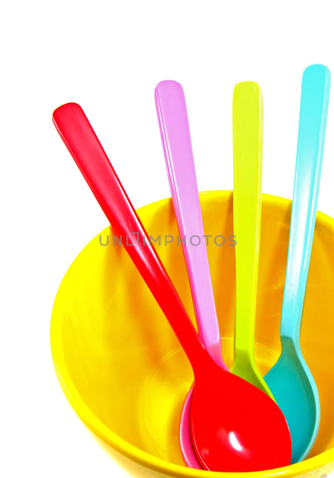 Group of plastic spoons in yellow bowl isolated on white