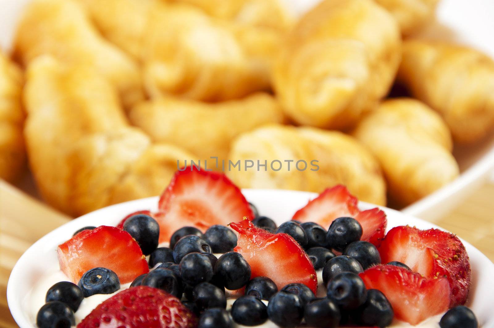 light Breakfast: croissants and Berries on a table on a light background