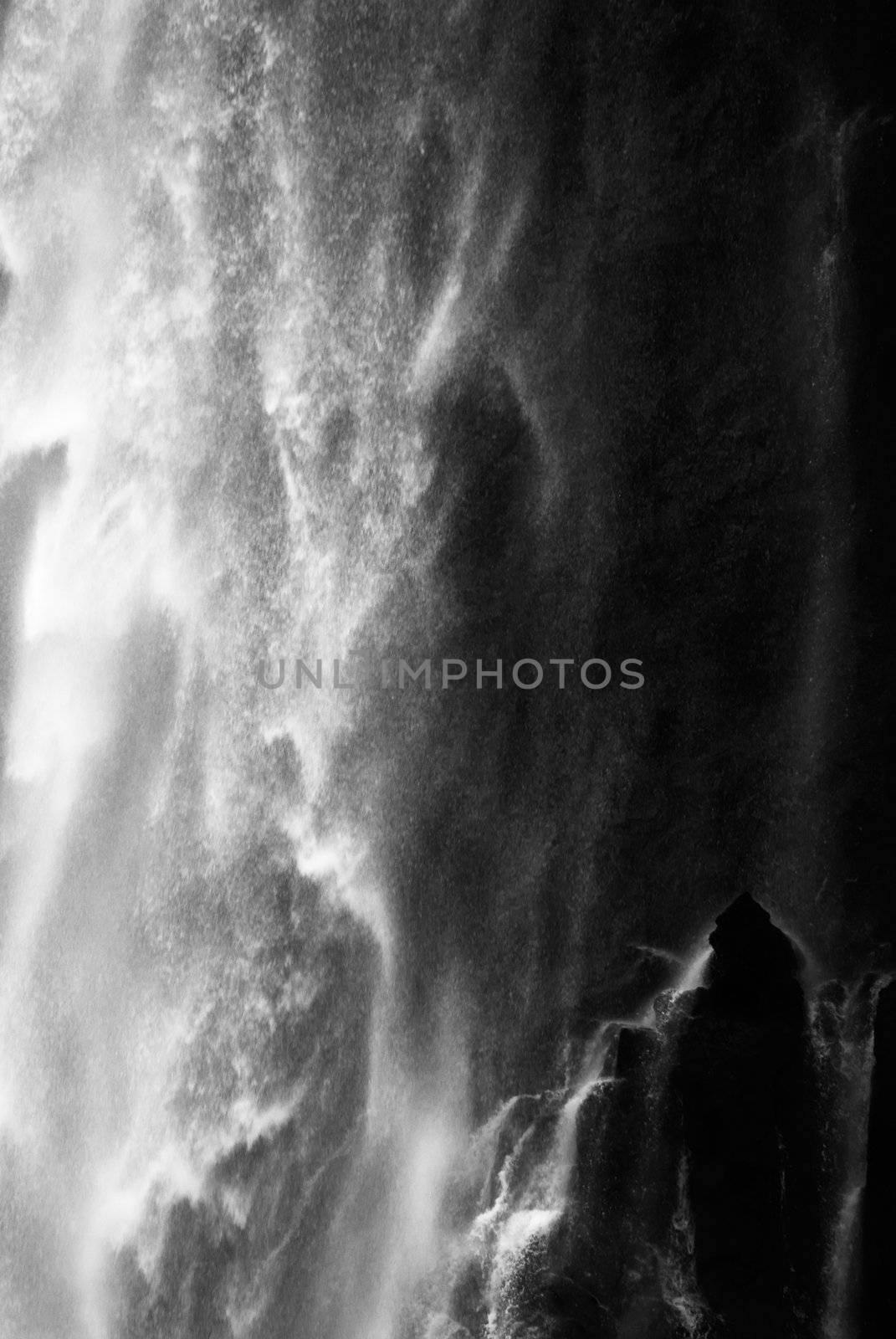 It is dramatic blurred view of waterfall flowing over rocks.