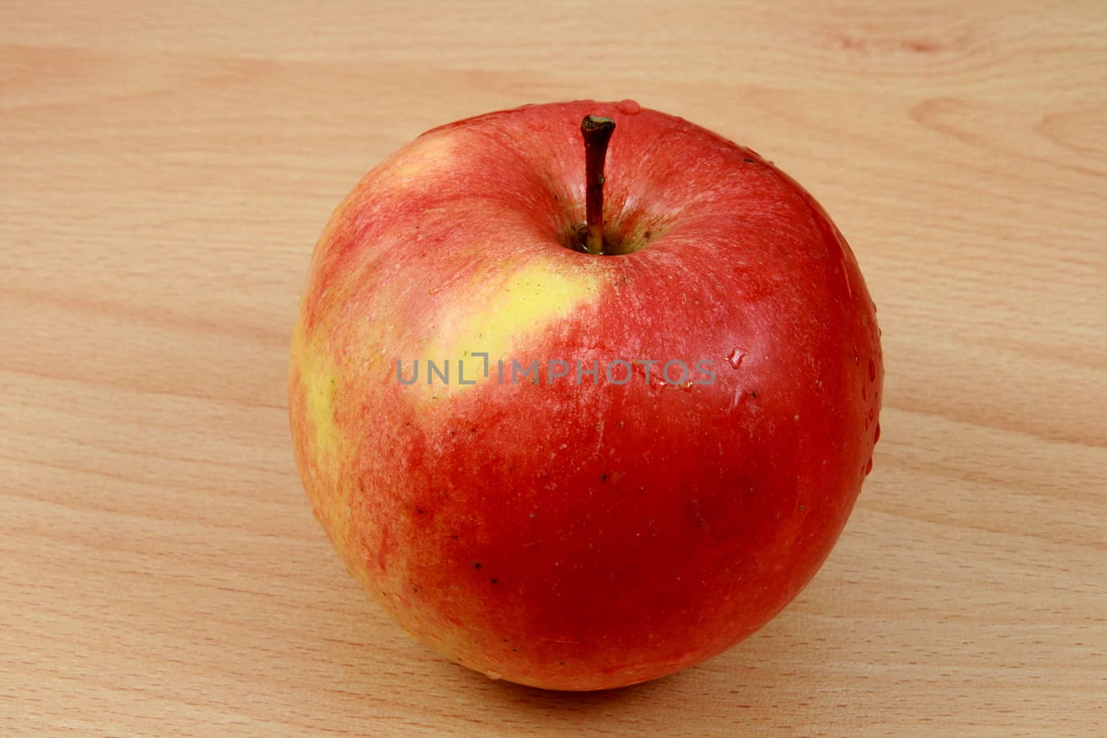 red apple on wooden desk