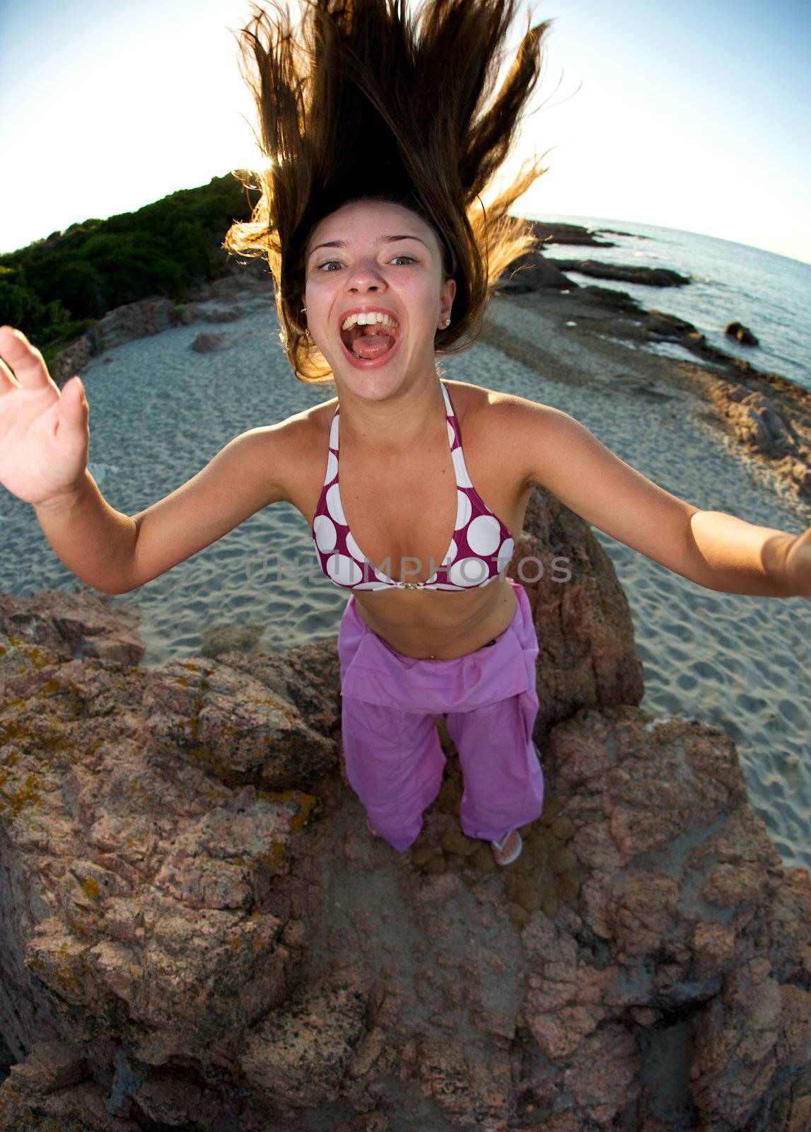 Crazy pretty woman enjoying the beach at sunset time