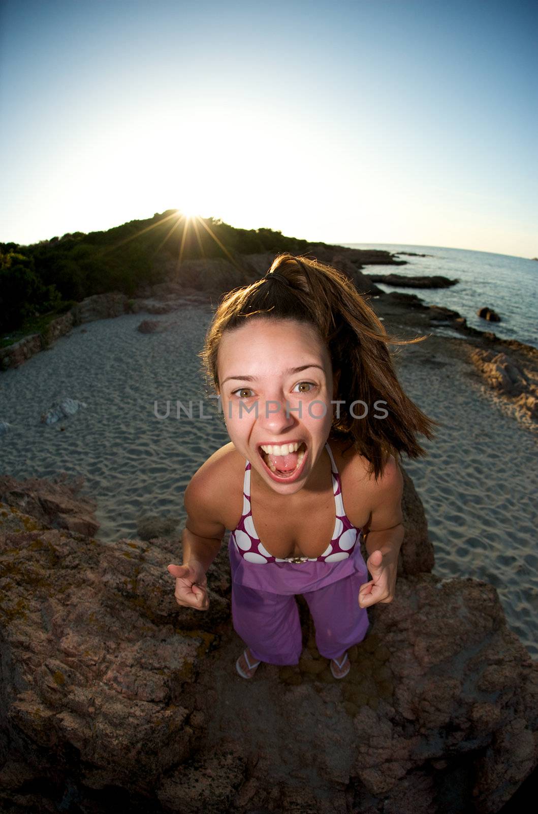 Crazy pretty woman enjoying the beach at sunset time