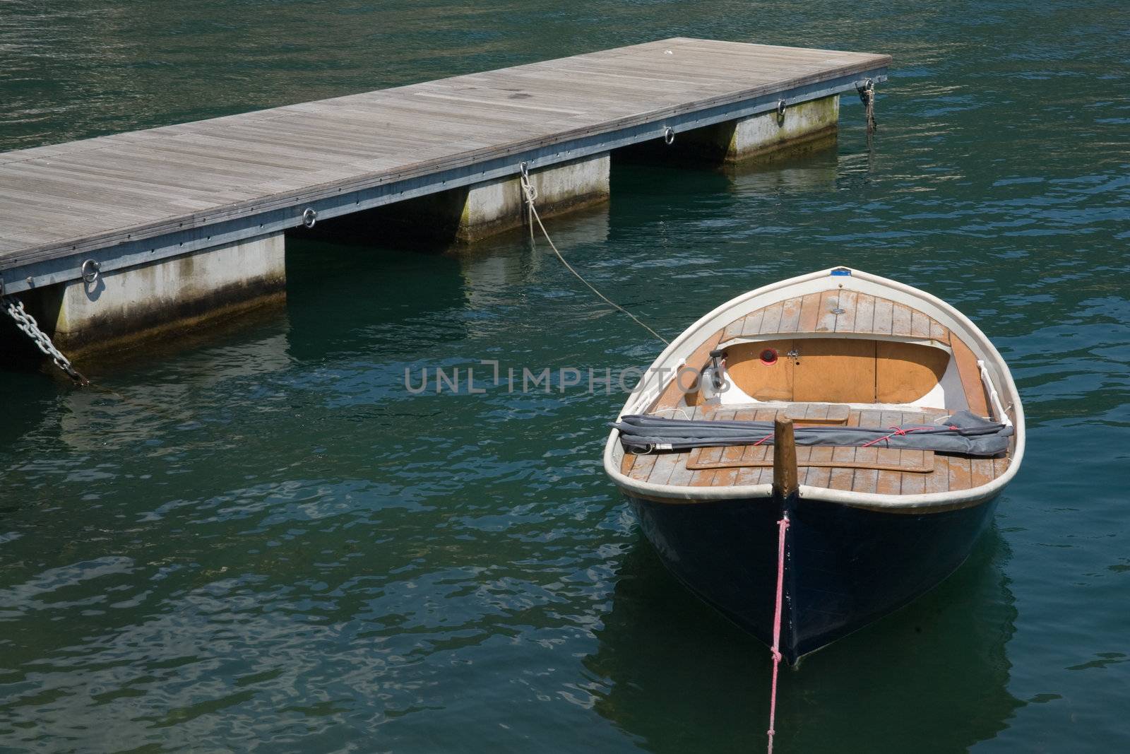 Wooden jetty and boat on Lake Como (Italy)