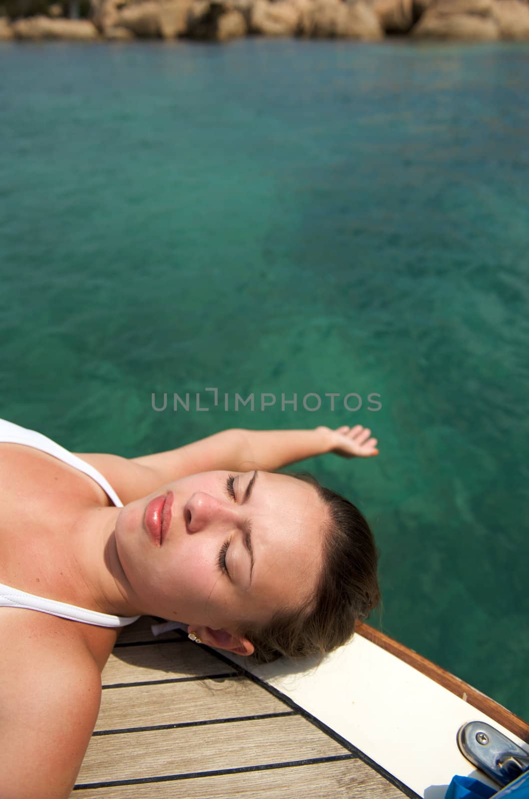 Pretty woman enjoying her trip on a sailboat