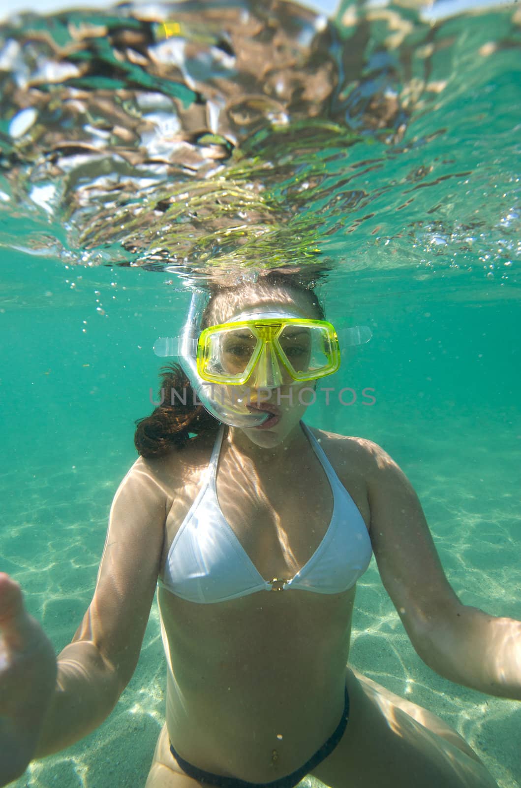 Woman doing snorkeling with goggles and scuba