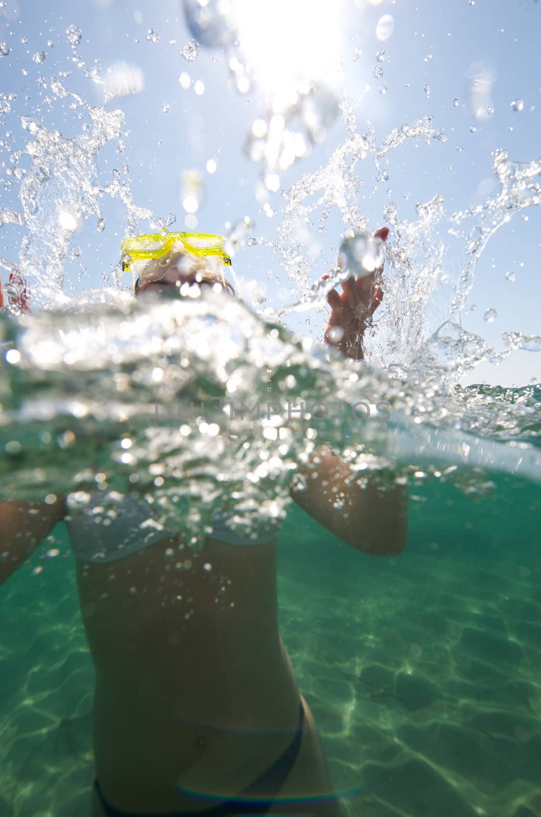 Woman doing snorkeling with goggles and scuba