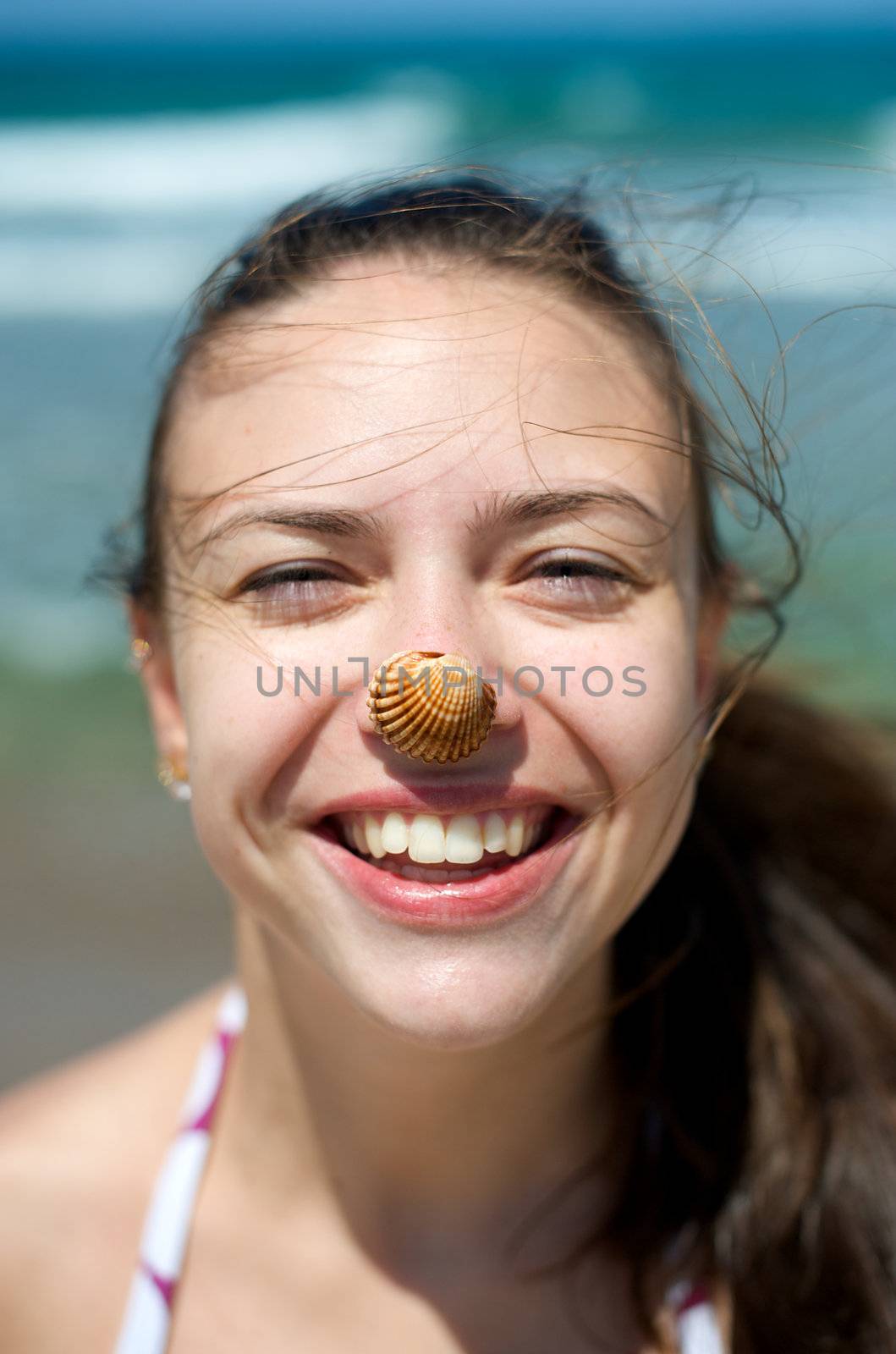 Woman playing with some shells on the beach